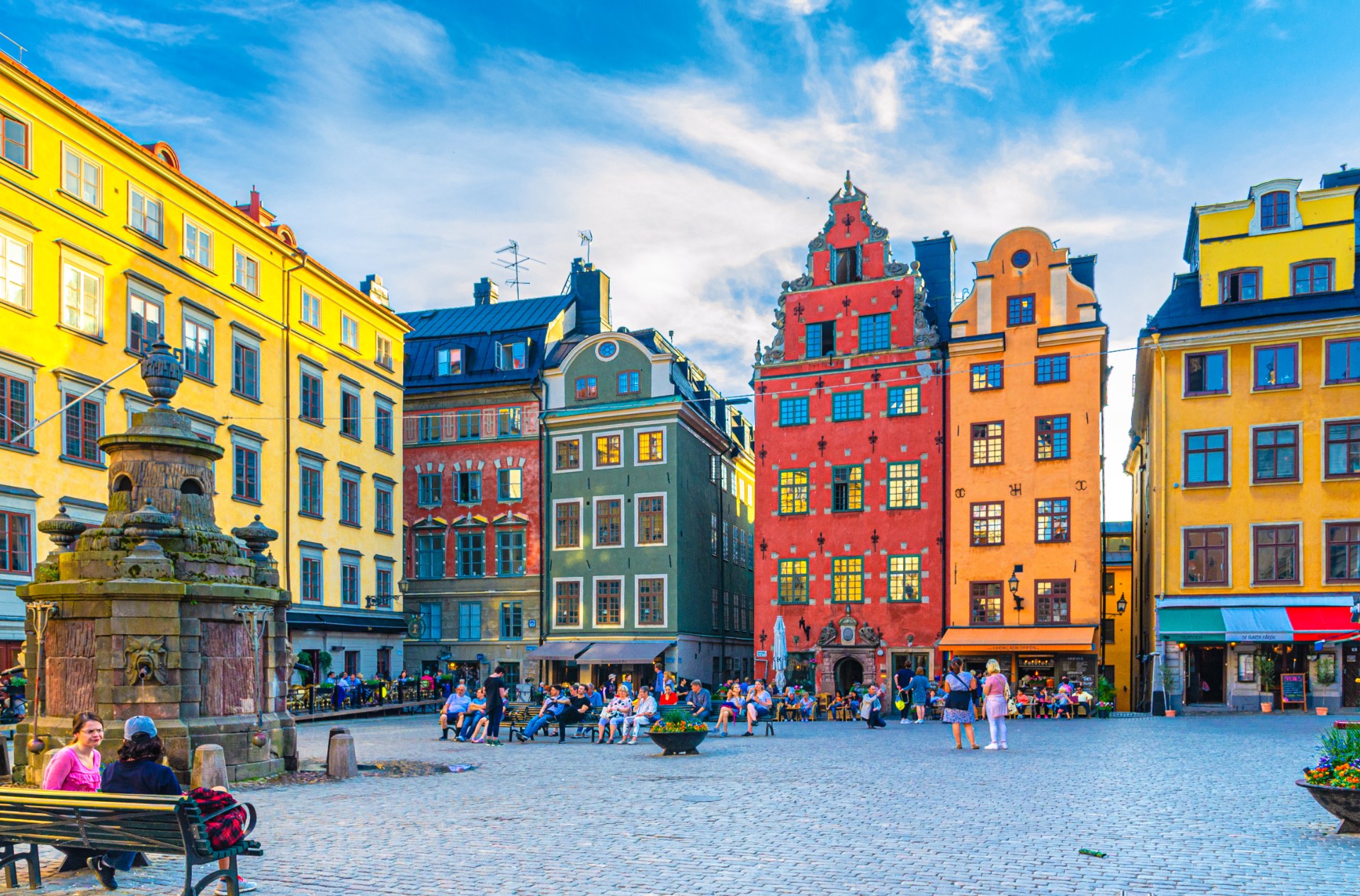 Tourists and passers-by on Stortorget square in Stockholm among colourful townhouses